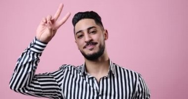 Happy businessman giving v hand sign