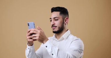 Young businessman text messaging on mobile phone
