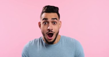 Cheerful young man celebrating victory 