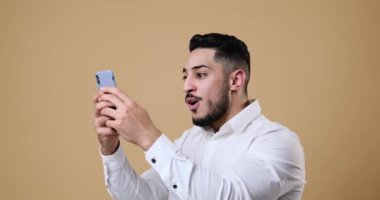 Businessman amazed on receiving good news using mobile phone