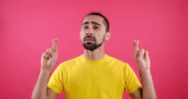 Man crossing his fingers and praying