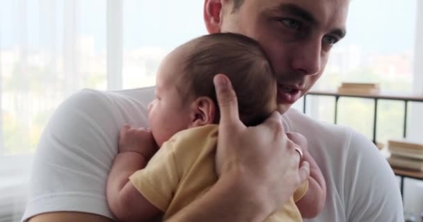 Young father soothing his crying baby son — Video Stock