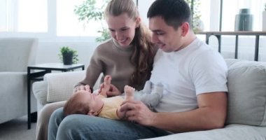 Young parents playing with baby son