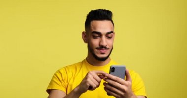 Man celebrating online success using mobile phone