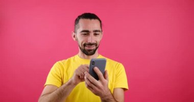 Happy man messaging using mobile phone