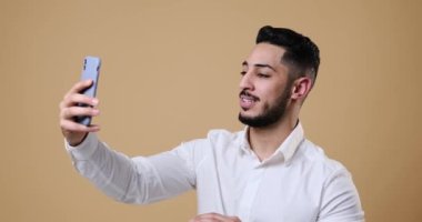 Young businessman video chatting on mobile phone