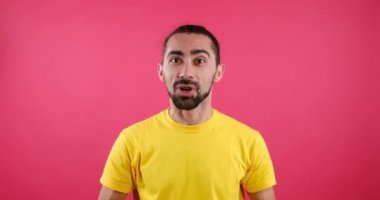 Happy young man vlogging over pink background
