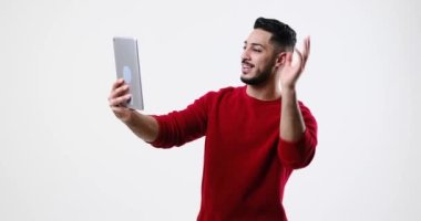 Young man video chatting on digital tablet