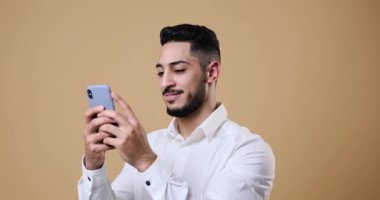 Young businessman text messaging on mobile phone