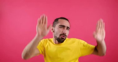 Crazy man dancing over pink background