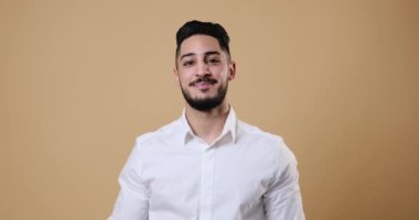 Young businessman greeting by waving hand