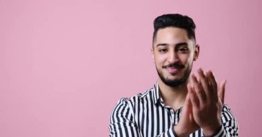 Young businessman applauding and smiling