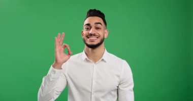 Young businessman showing ok gesture with hand