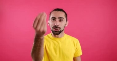 Man vlogging over pink background