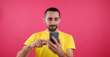 Happy man messaging using mobile phone