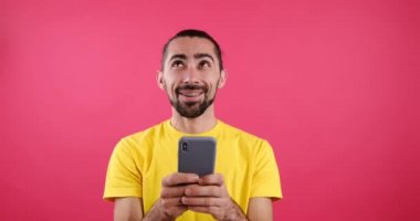 Happy man messaging using mobile phone