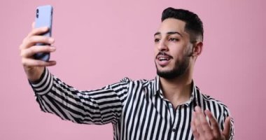 Young businessman video chatting on mobile phone