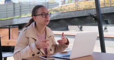 Young businesswoman gesturing while using laptop for video conference