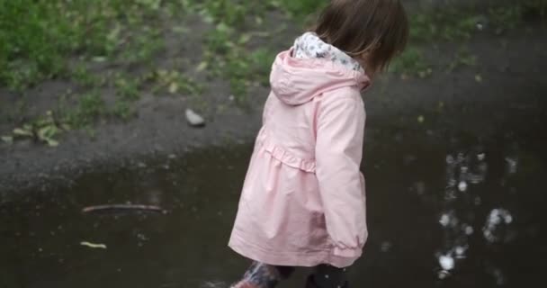 Girl walking in puddle water — Stock Video