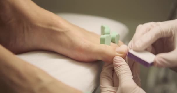 Pedikérka čištění nehty nohou klienta — Stock video