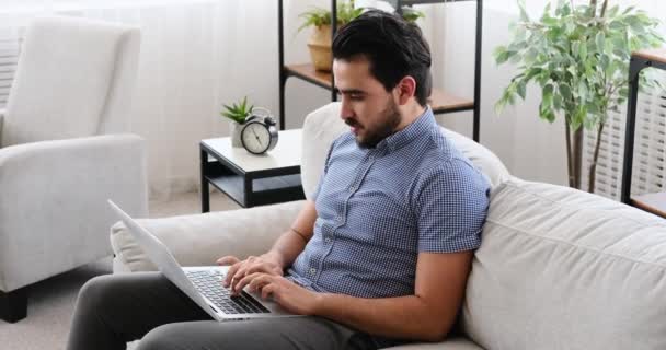 坐在沙发上使用笔记本电脑的商人 — 图库视频影像
