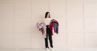 Kadın yere kıyafet atıyor.