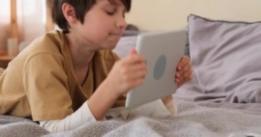 Çocuk yatağa dijital tablet kullanma