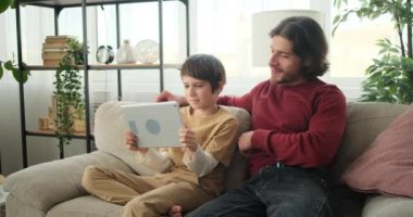 Çocuk ve babası dijital tablette oynuyorlar
