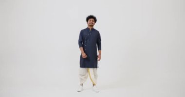 Indian man in traditional clothing showing thumbs up
