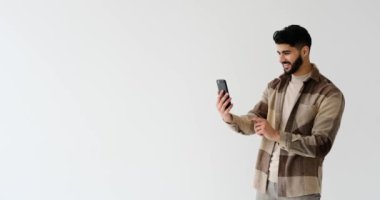 Heyecanlı genç adam cep telefonundan mesaj atıyor