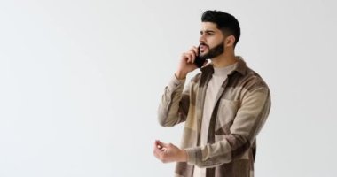 Young man talking on mobile phone over white background
