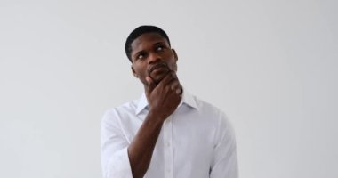 Confused businessman coming up with a good idea over white background