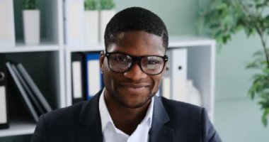 Portrait of happy african american businessman in formalwear at office