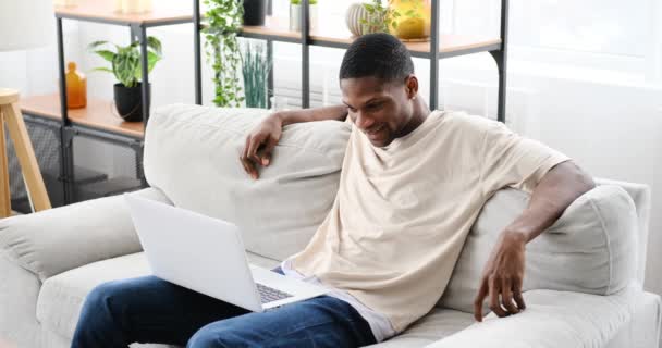 African American Man Laughing While Watching Funny Movie Laptop Home — Αρχείο Βίντεο