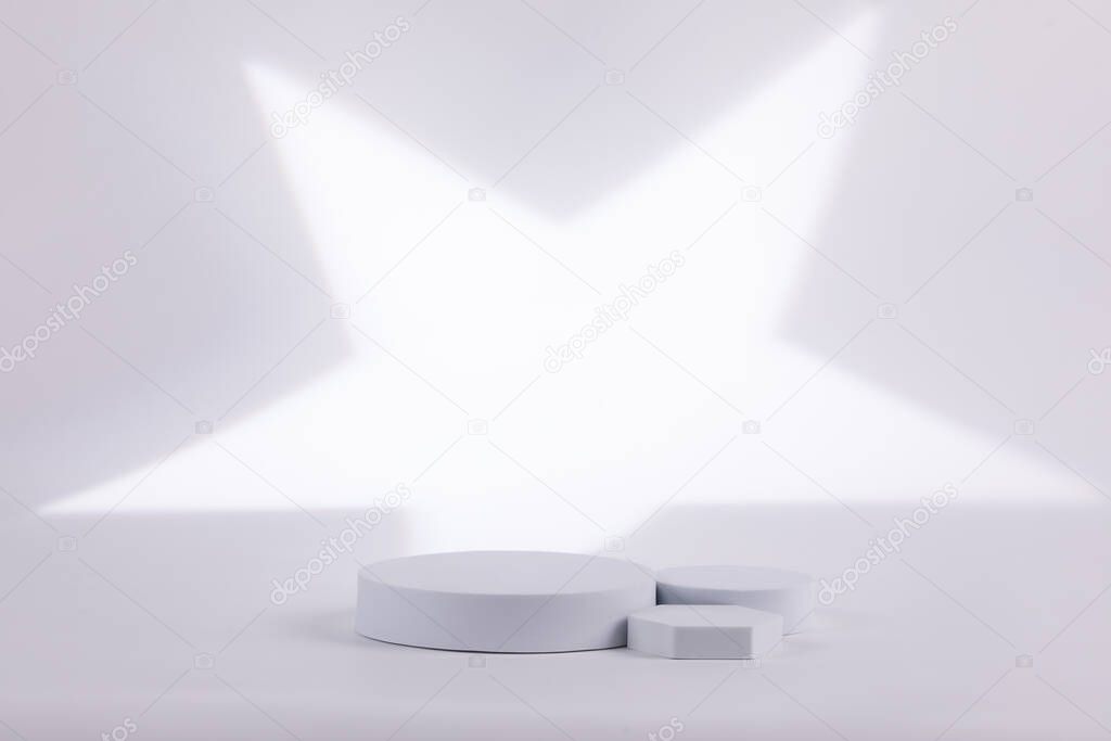 Gray background with a white start shape behind for product commercial. Made out of geometric forms