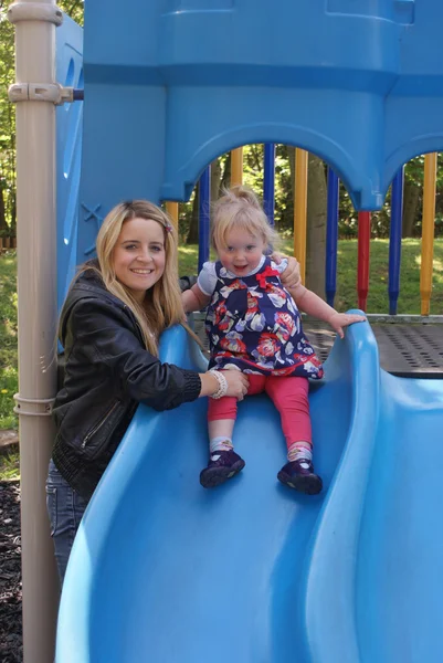 Young child on blue slide — Stock Photo, Image