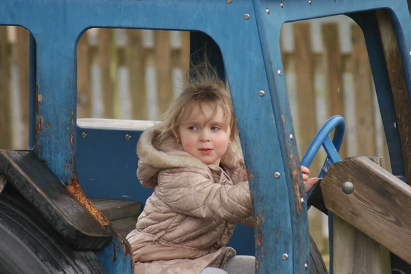 Young Girl Playing in Blue Tractor — Stock Photo, Image