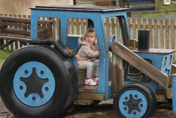 Young Girl Playing in Blue Tractor — Stock Photo, Image