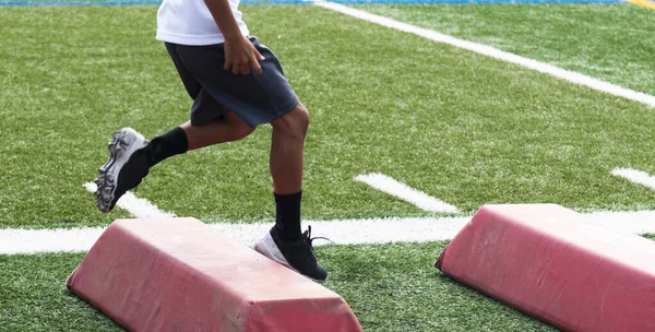 Young Football Player Running Red Barriers Pre Season Summer Camp — Zdjęcie stockowe