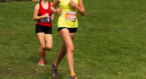 Two High School Girls Running Race Grass Field — Stock Photo, Image