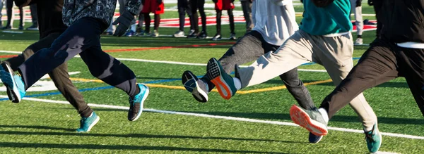 High School Athletes Performing Running Drills Turf Field Cold Day — стоковое фото