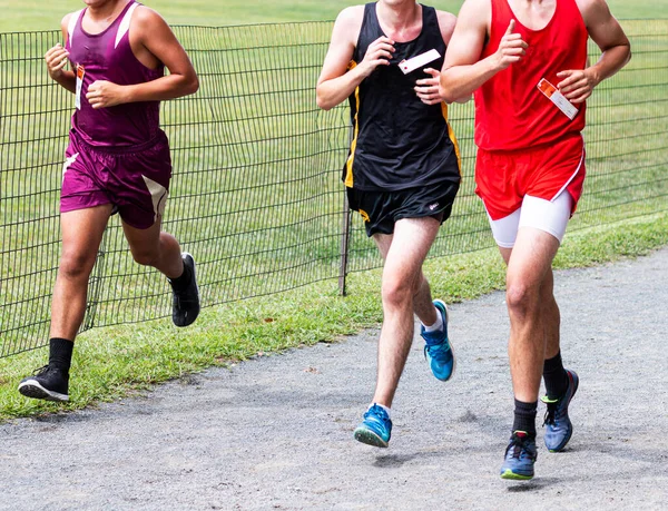 Three High School Boys Racing Final Straightway Gravel Path Van — Zdjęcie stockowe