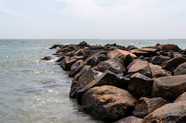 Large rock jetty extending out into Narragansett Bay close to Roger Wheeler State PArk Beach.