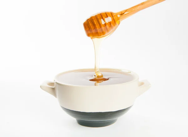 Juicy honey in a cup and spoon — Stock Photo, Image