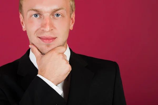 Businessman close-up on a red background. — Stock Photo, Image