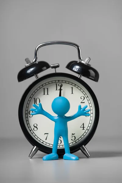 Blue man and an alarm clock. — Stock Photo, Image