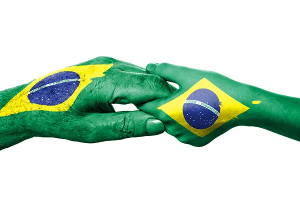 Zwei Hände und brasilianische Flagge — Stockfoto