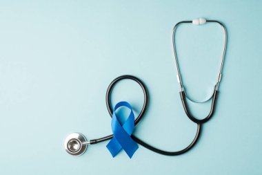 Stetoskop ve mavi ipek kurdele sembolü prostat kanseri bilinci izole edilmiş pastel mavi arkaplan ve boş alan