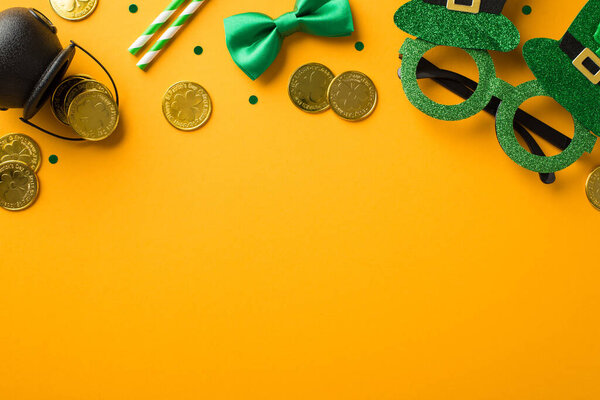 Top view photo of st patrick's day decorations hat shaped party glasses straws green bow-tie confetti and pot with gold coins on isolated yellow background with blank space