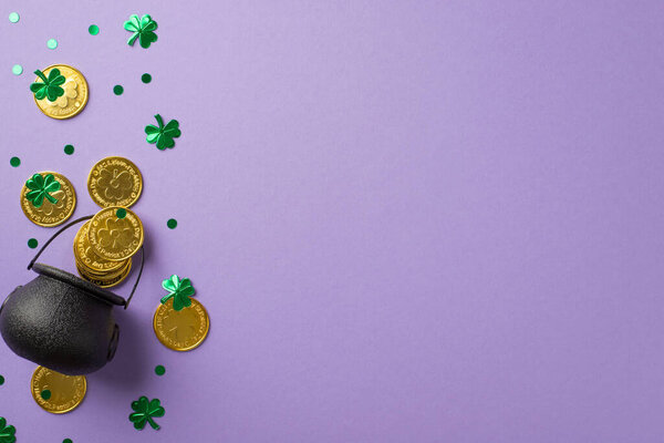 Top view photo of saint patrick's day decorations pot with gold coins and green clover shaped confetti on isolated pastel violet background with copyspace